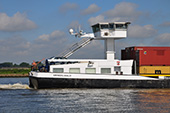 Containerschip <em>Grindelwald</em> met beweegbaar stuurhuis bij Dordrecht, 2014. De meeste containerschepen beschikken over een beweegbaar stuurhuis omdat ze vaak met een hoge lading varen. Dit geeft de stuurman, wanneer het stuurhuis in hoge stand staat, een goed overzicht over de vaarweg, terwijl hij bij een lage stand onder lage bruggen door kan varen.