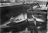 Varen is teamwerk, 1941. Een met turf beladen zeilschip, voortbewogen door een opduwer, vaart de sluis Meesterverlaat in het Ter Apelkanaal in Groningen in. Aan het roer van het zeilschip moeder Trijntje Beijert, die het roer heeft verlengd en op een verhoging staat om over de lading te kunnen kijken. In de opduwer haar zoon Taeke. Op het voorschip houdt vader Beijert, slechts gedeeltelijk zichtbaar, het schip af met een pikhaak. Duidelijk is dat de schippersvrouw aan boord niet alleen huishoudelijke taken vervulde, maar ook in het vaarbedrijf een belangrijke functie vervulde.